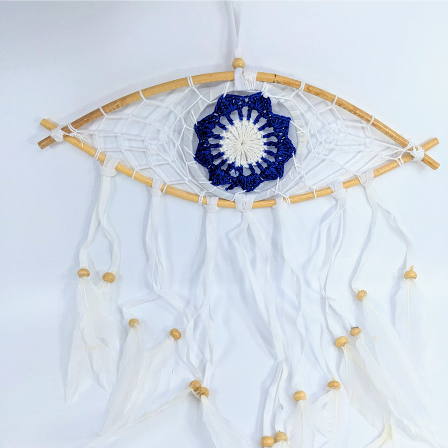 Eye-shaped Evil Eye wood dreamcatcher with blue and white crochet center and tassels