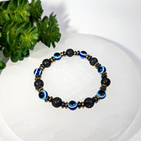 Blue and black evil eye lava bead bracelet with gold accents, 7.5’’ #BC0266