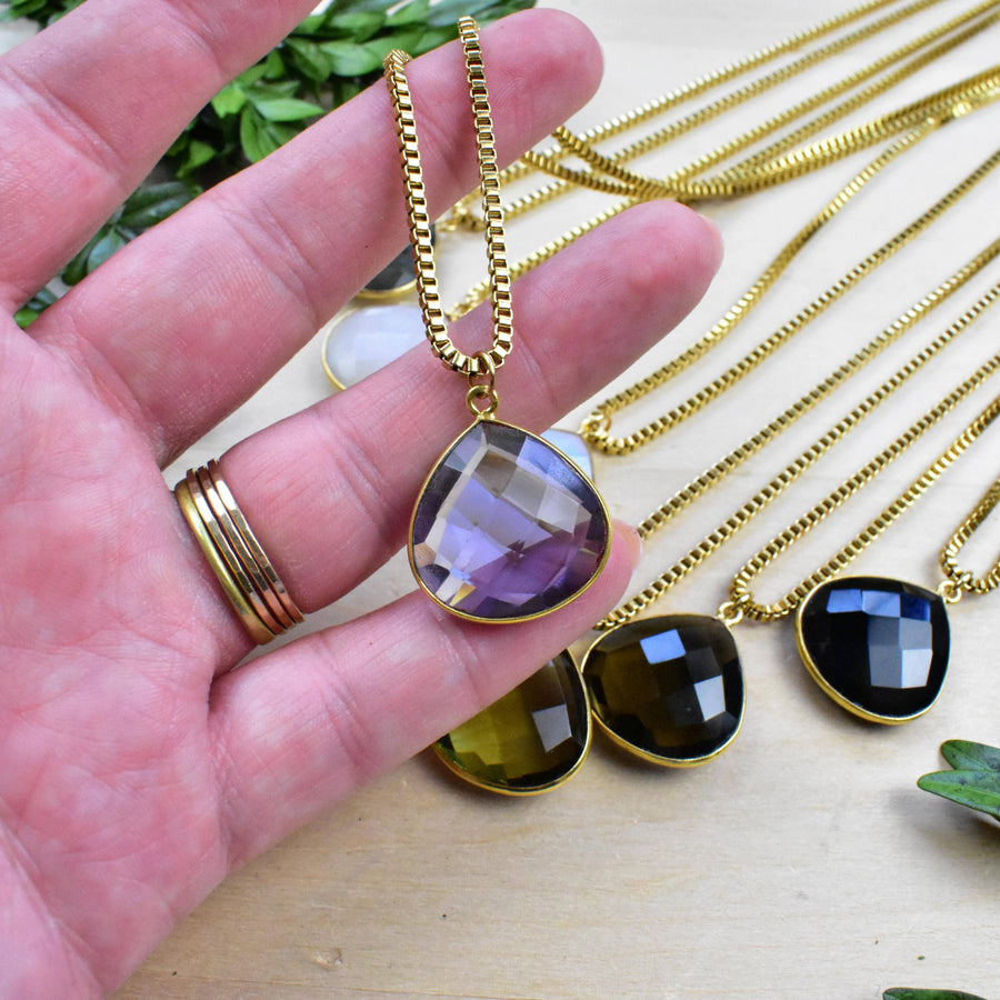 Hand holding gold Faceted Teardrop Amethyst Necklace LV9394