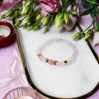 White and pink beaded fertility bracelet with rose quartz, moonstone, and gold accents LV9545