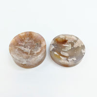 Thumbnail for Two large brown and white quartzs in Flower Agate 2.1’ Sphere Holder Dish #LV2732