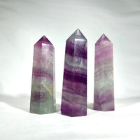 Thumbnail for Fluorite Towers 2.5 - 3’ #G176: three amethite crystals on a white background