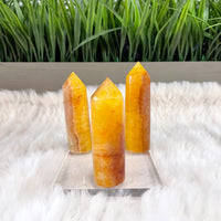 Thumbnail for Fluorite Towers 2.5-3’: Two orange quartzite crystals on white fur rug