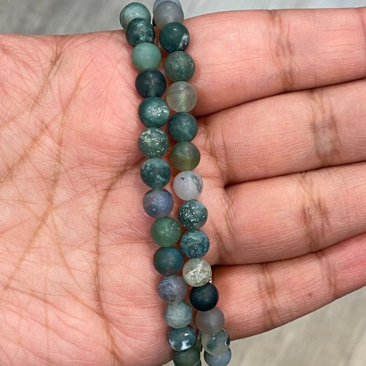 Frosted Bracelet #J586 showcases blue-green and gray beads, perfect for referral history