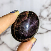 Thumbnail for Person holding large purple Garnet aka Almandine palm stone #LV1428