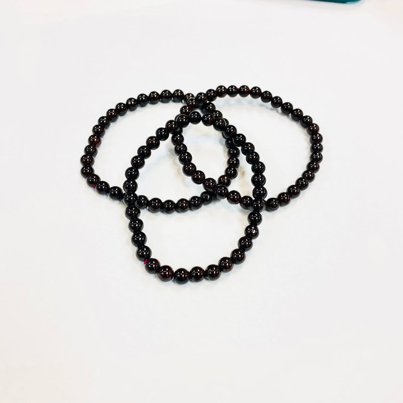 Black beaded necklace in circular loop showcasing Garnet Beaded Bracelet design