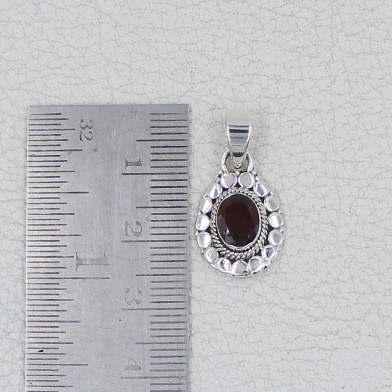 Sterling silver teardrop pendant with faceted oval garnet and circle designs #BC0409