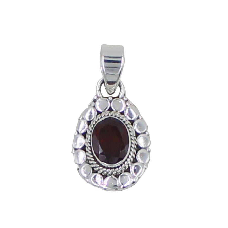Silver pendant with a red gemstone on a light gray background