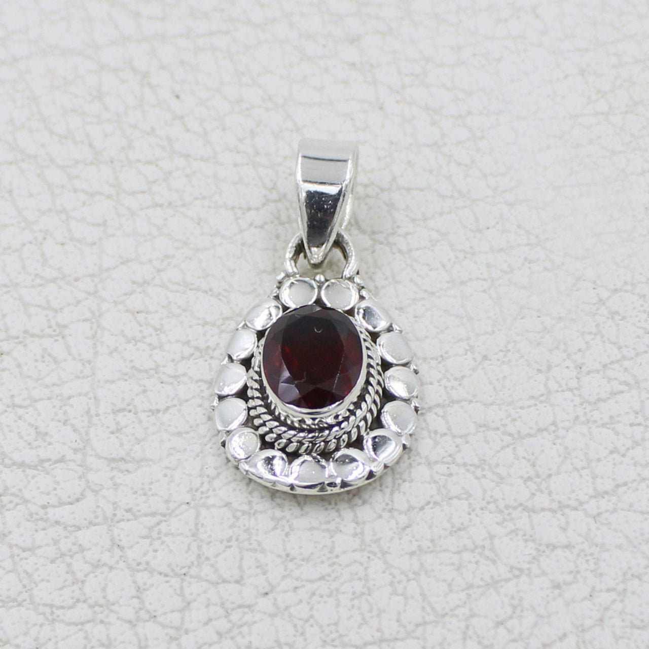 Garnet faceted oval sterling silver pendant with circle designs #BC0409