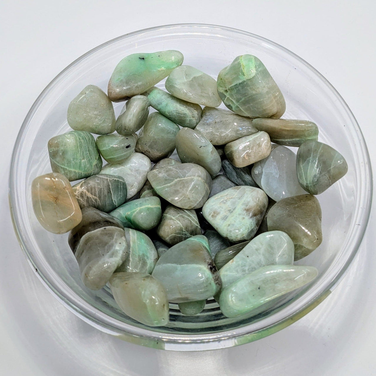 Polished green aventurine stones in a glass bowl for Garnierite Tumbled product