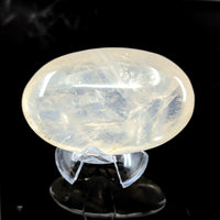 A translucent oval-shaped milky white girasol quartz 3.2 inch jumbo pebble with visible internal crystalline patterns