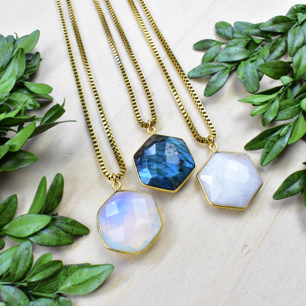 Three gold hexagon necklaces with moonstone and labradorite gems