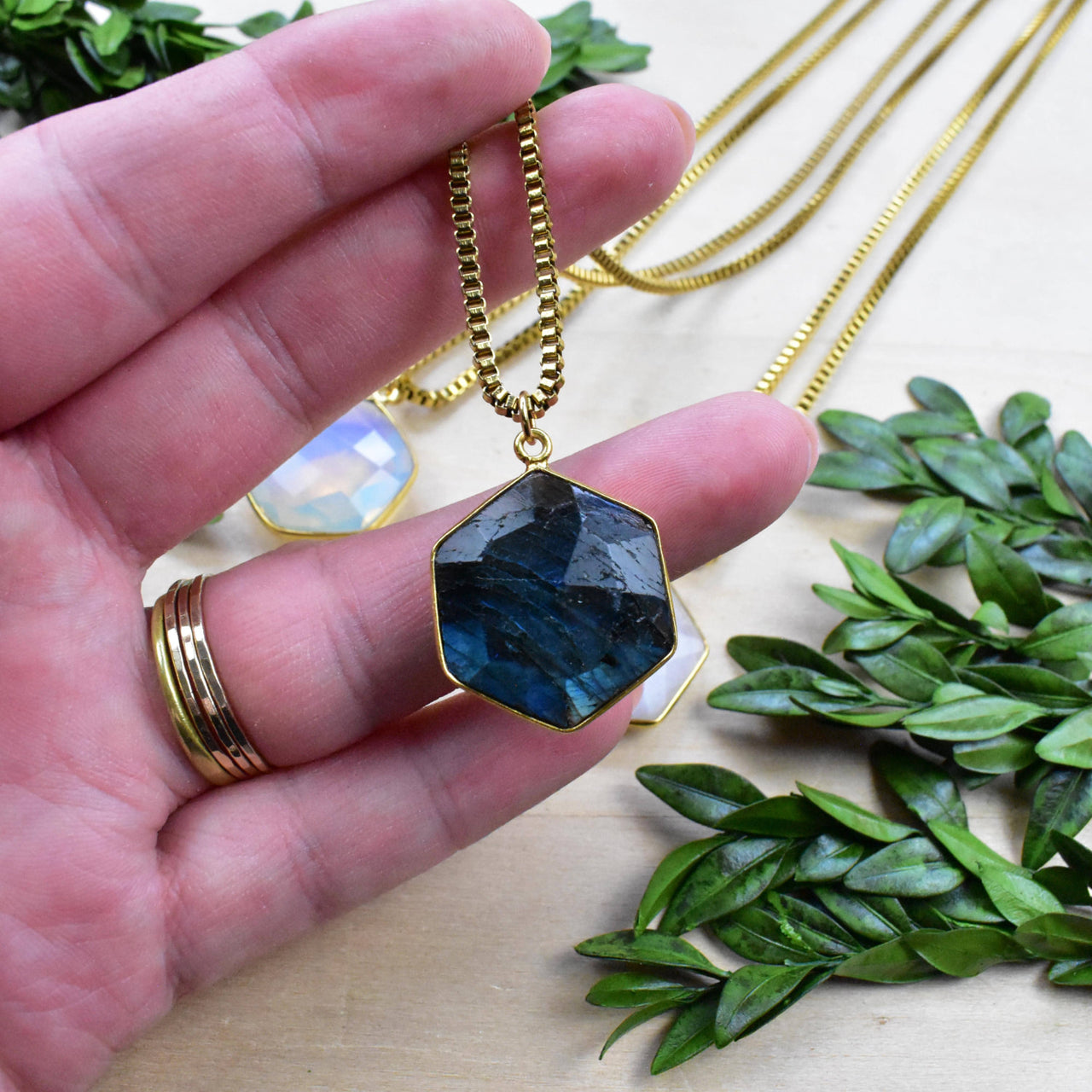 Deep blue hexagonal labradorite pendant in gold frame on chain, LV9393