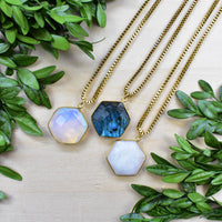 Three gold faceted hexagon labradorite opal necklaces in blue, white, lavender