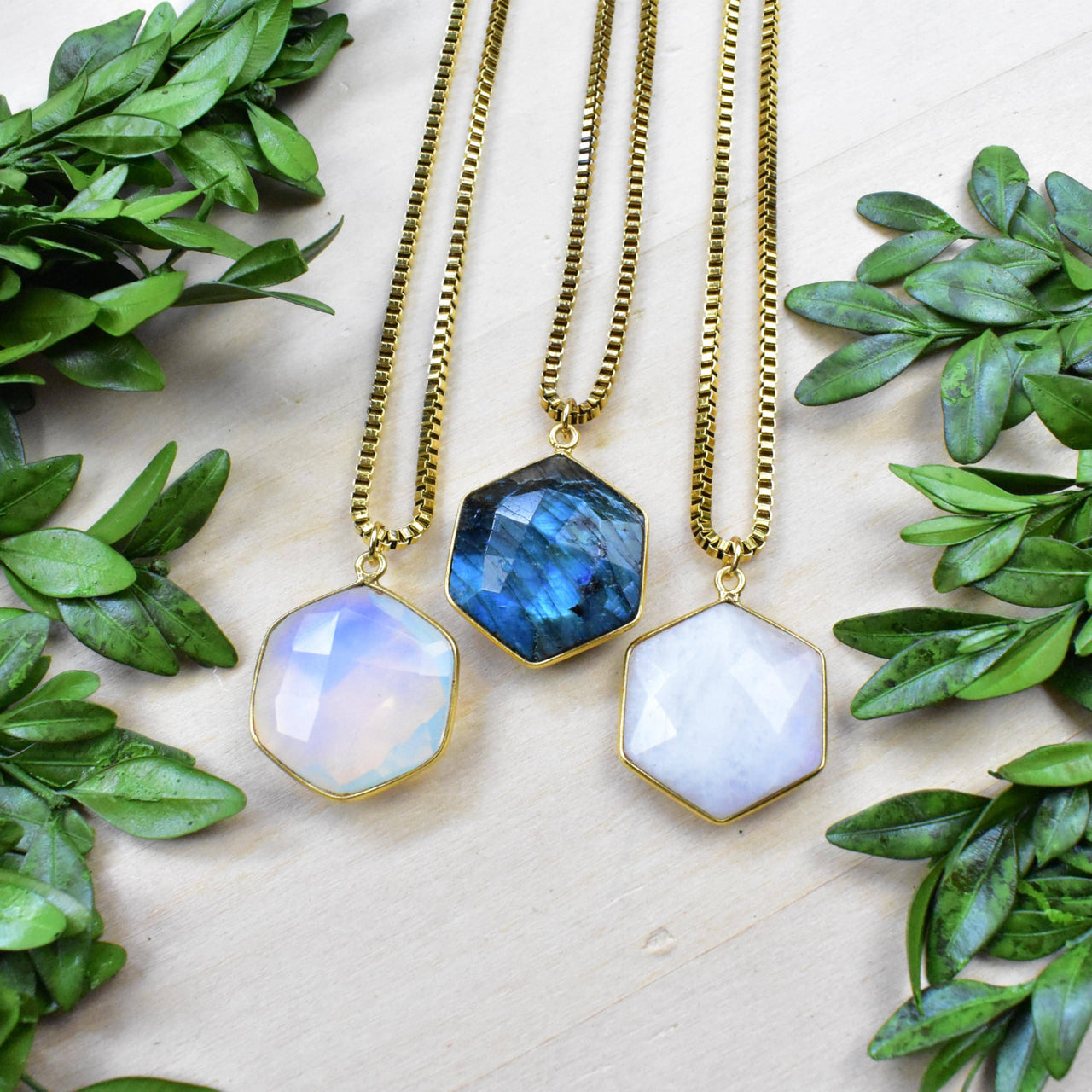 Three gold faceted hexagon gemstone necklaces with labradorite and moonstone