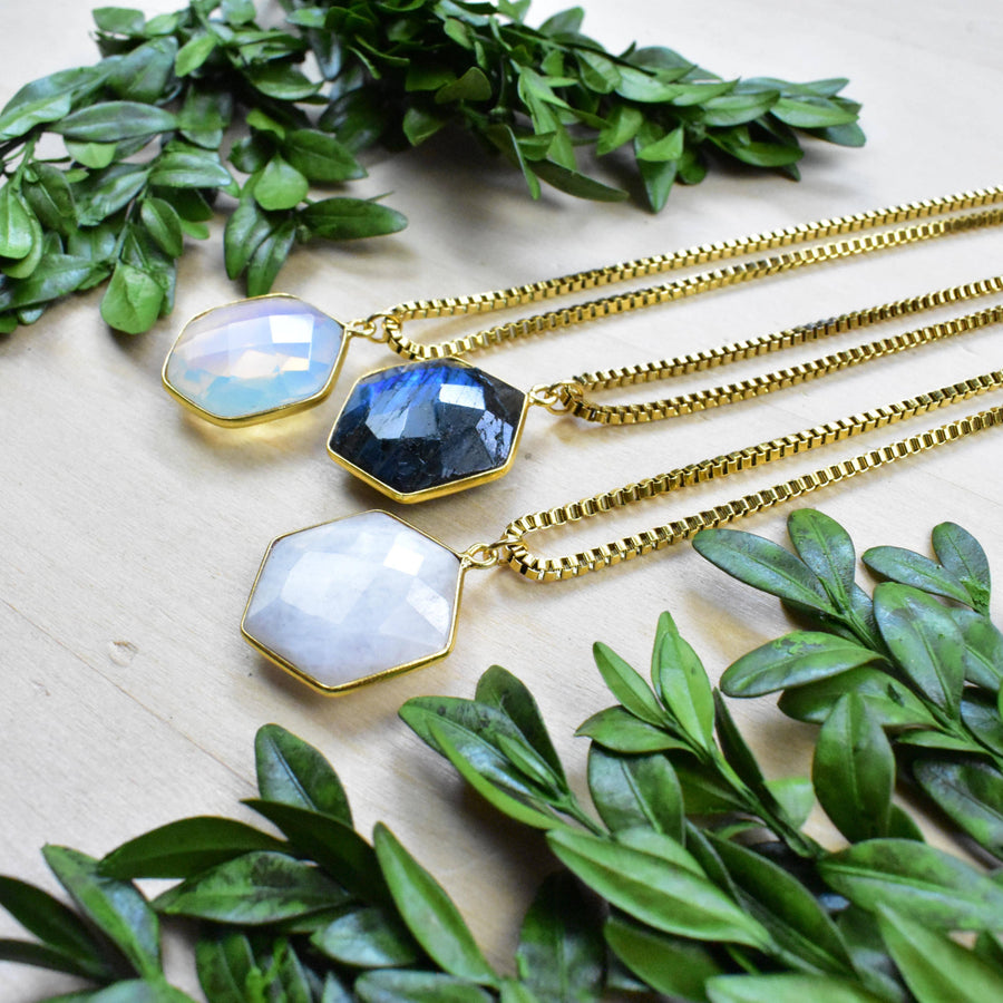 Three gold faceted hexagon gemstone necklaces with opal, labradorite, moonstone