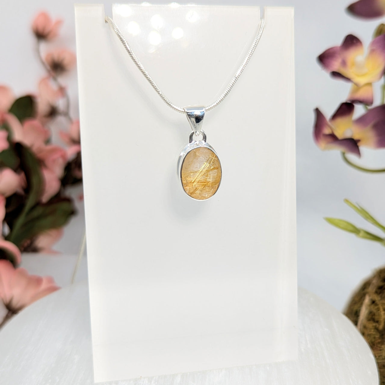 Silver necklace with gold rutilated quartz pendant for spiritual growth and uplifting energy