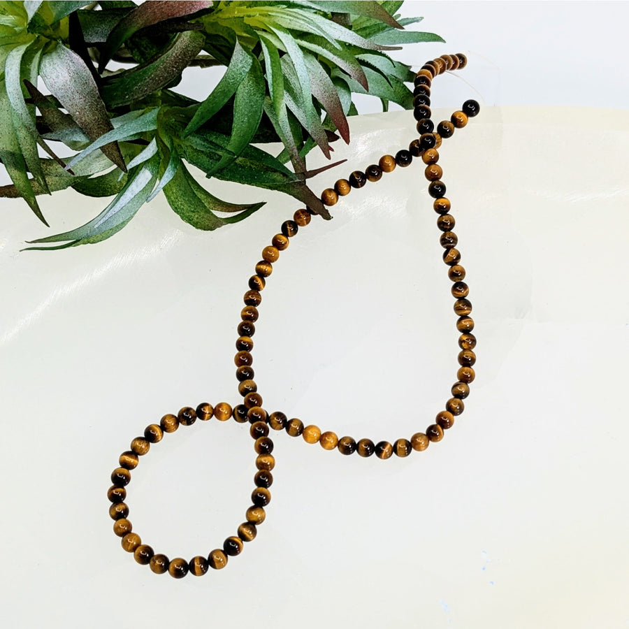Gold Tiger’s Eye 4mm Round Beads Strand arranged in a stylish figure-eight pattern