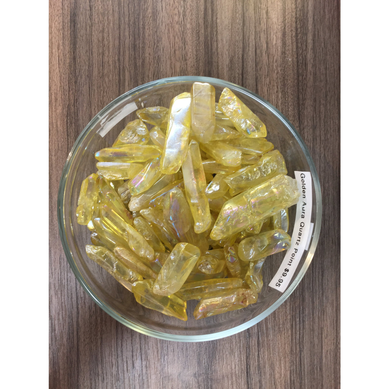 Yellow-tinted Golden Aura Quartz points arranged in a decorative glass bowl