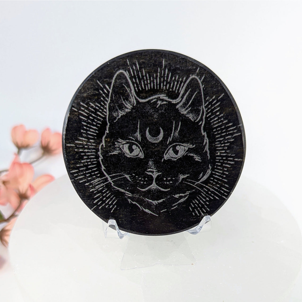 Round black engraved coaster with celestial cat face design from Goldsheen Obsidian Plate