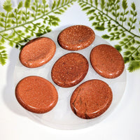 Six 2in goldstone thumb stones #BC1237 on clear plate