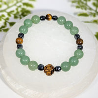 Good luck 8 inch multi stone bracelet with jade, tiger eye, black magnetic beads, and a carved wooden lion charm jewelry