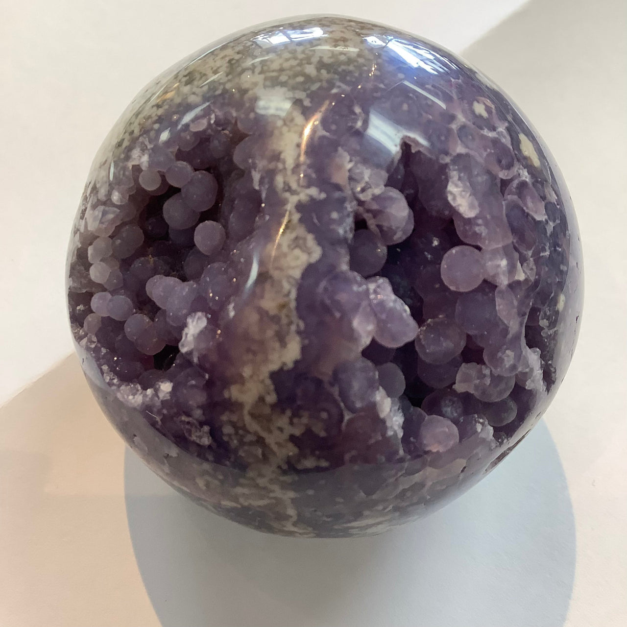 Purple amethyst grape agate sphere with botryoidal formations for crystal collectors