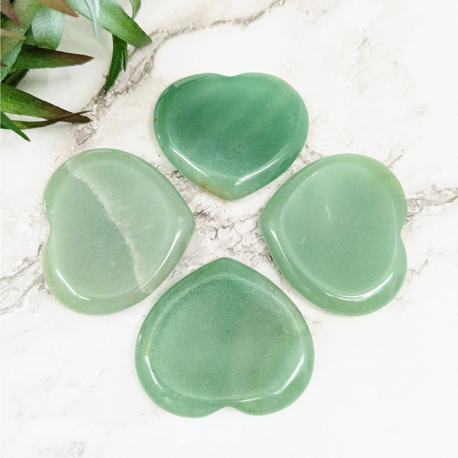 Four green heart-shaped Aventurine stones for thumb healing and energy cleansing