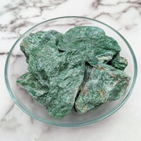 Thumbnail for Close-up of Green Fuchsite Rough Stone in a bowl on a marble counter, product #LV1498