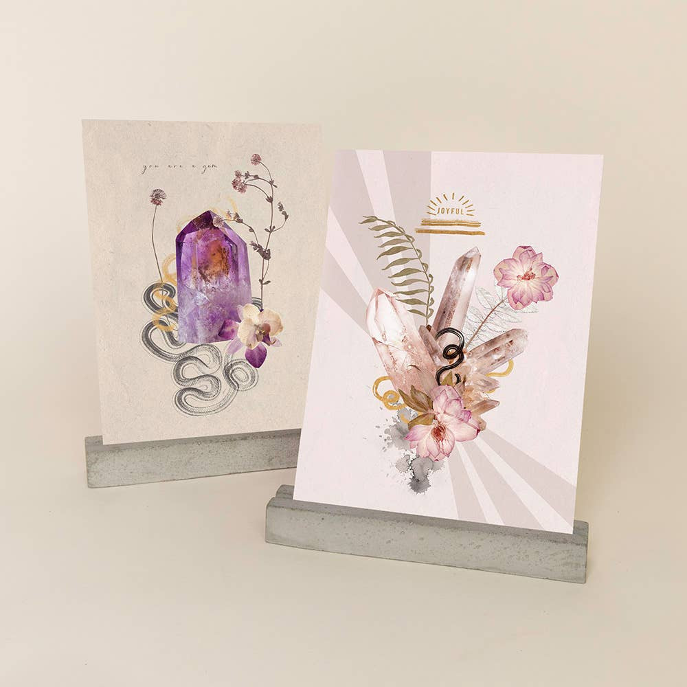 Two decorative art prints with crystals and flowers on concrete stands for Gem Greeting Card