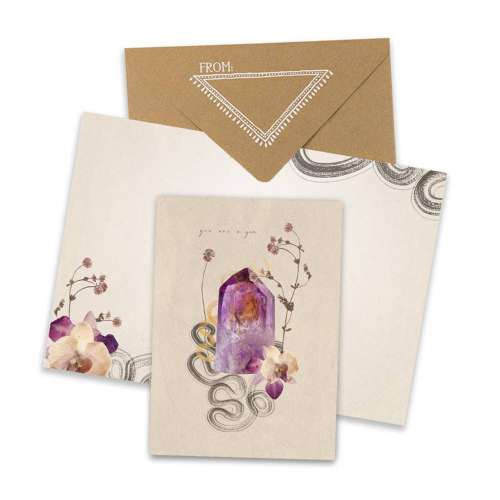 Decorative stationery set with purple crystal, floral elements, and snake motif design