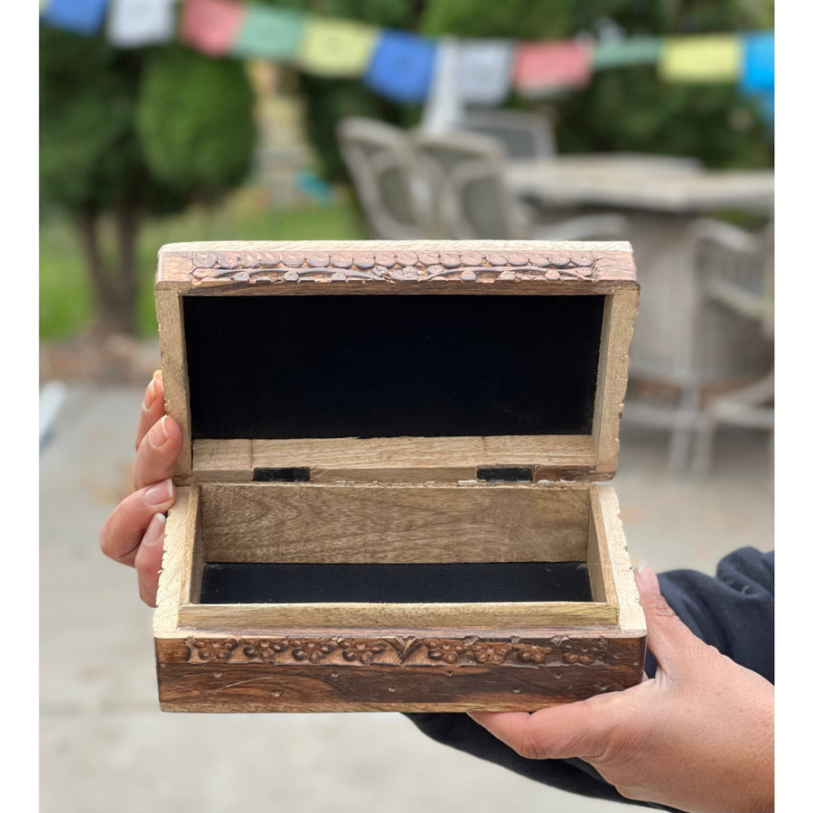 Open carved wooden lotus box with black lining for elegant storage