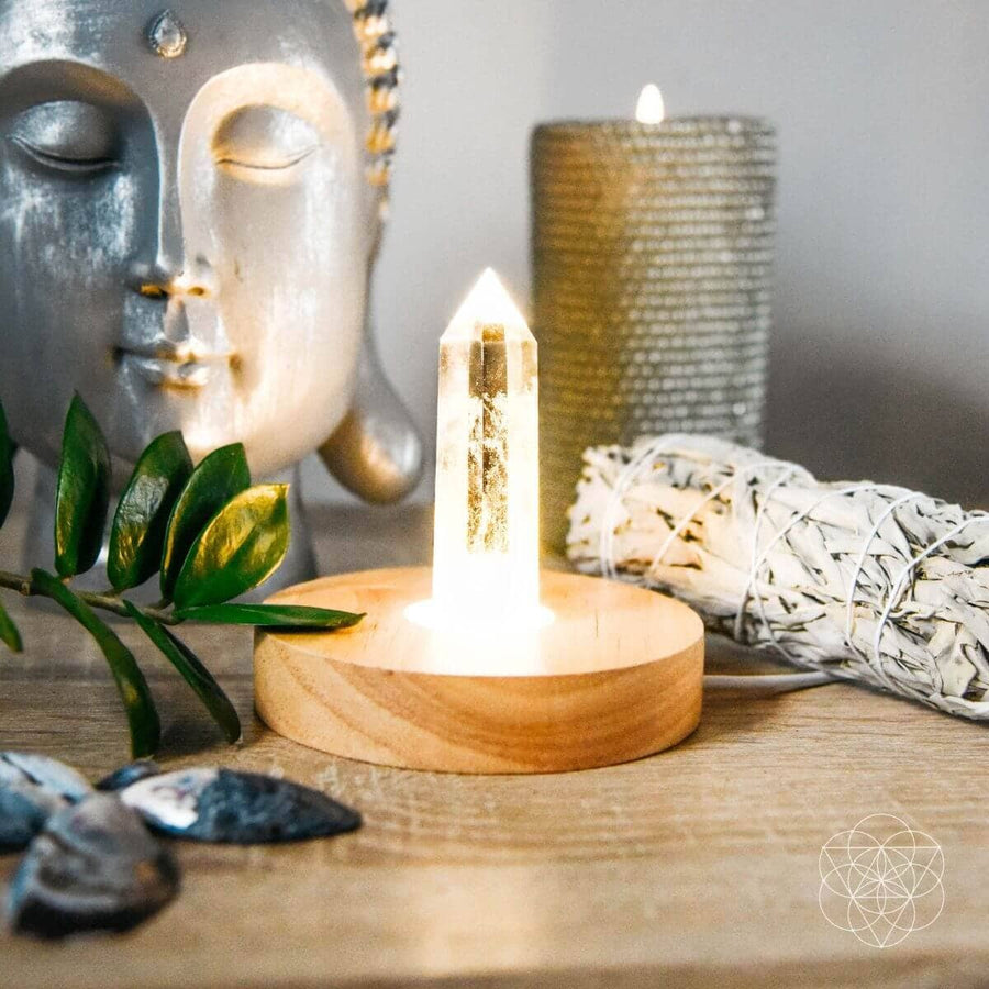 Wooden crystal light stand with glowing quartz point lamp