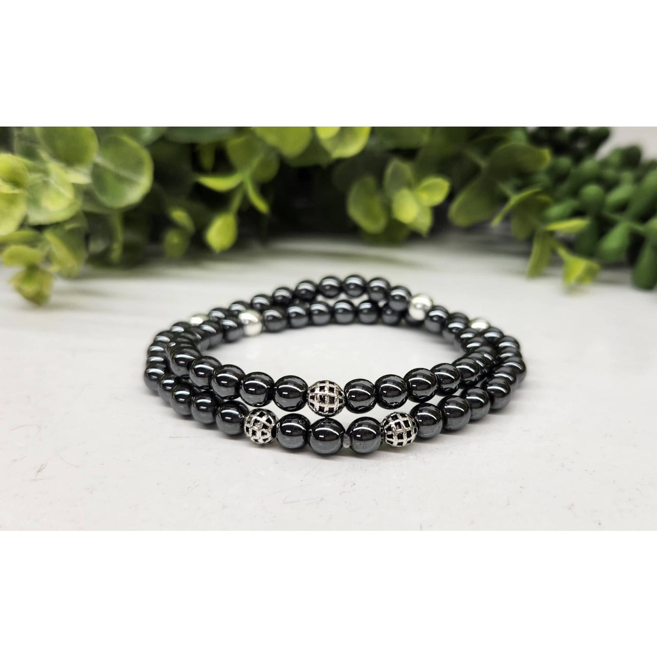 Black hematite double twist bracelet with silver accents and patterned beads