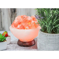 Thumbnail for A close up of Himalayan salt next to a potted plant in a ’Fire On Ice’ salt lamp