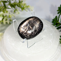 A polished black and silver metallic hypersthene 1.7 inch smooth oval palm stone for meditation and healing