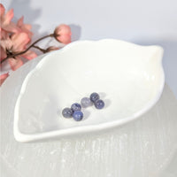 Polished translucent iolite round beads 6mm in leaf dish