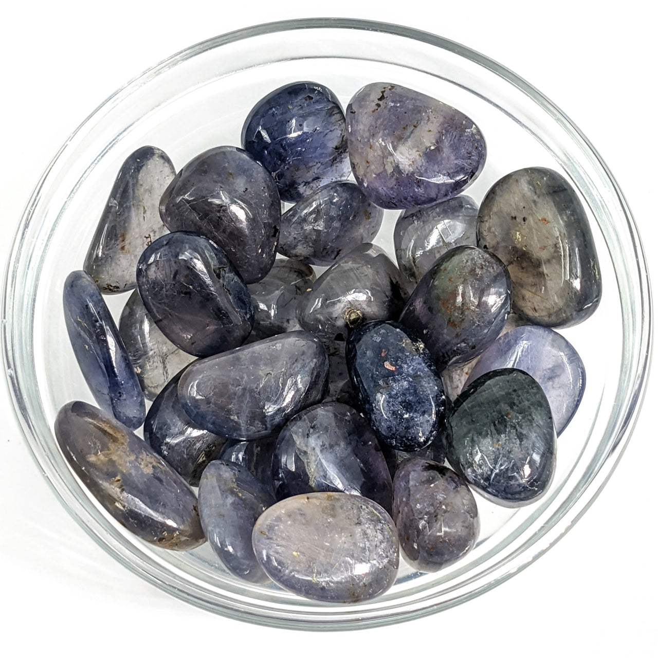 Iolite Translucent Tumble Stone Grade A #SK9125 in a bowl filled with blue and white crystals