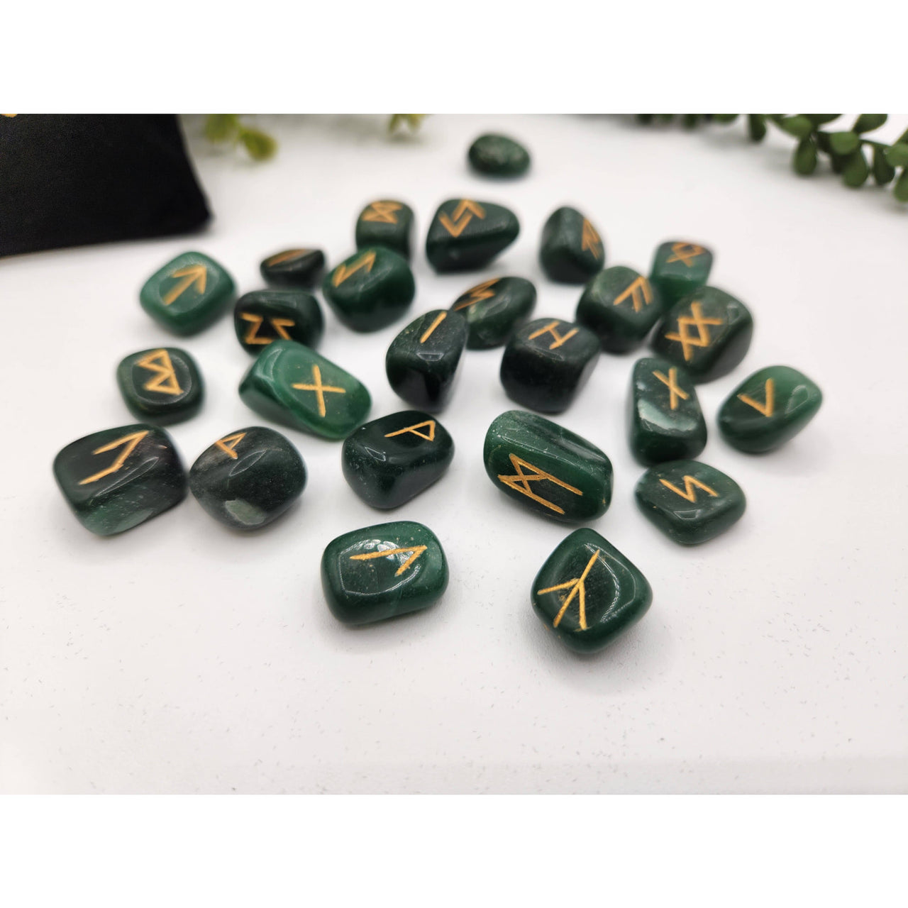 Jade green stone runes with gold markings and velvet pouch