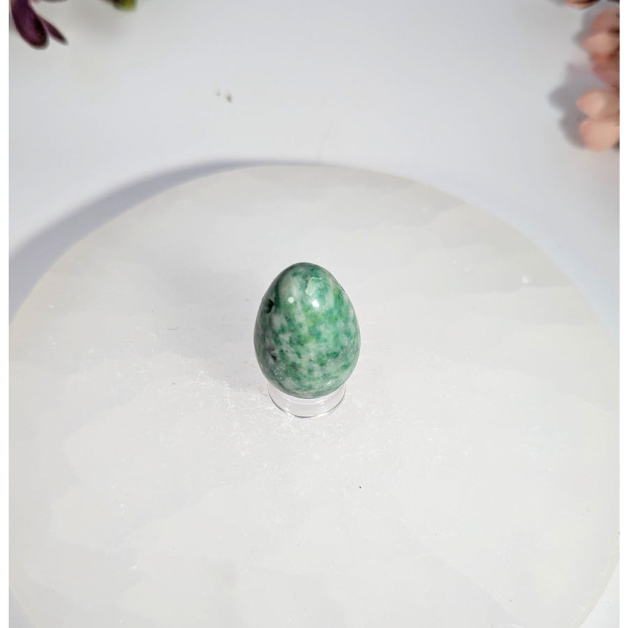 Polished green and white speckled jade yoni egg with hole, 1-2 inches