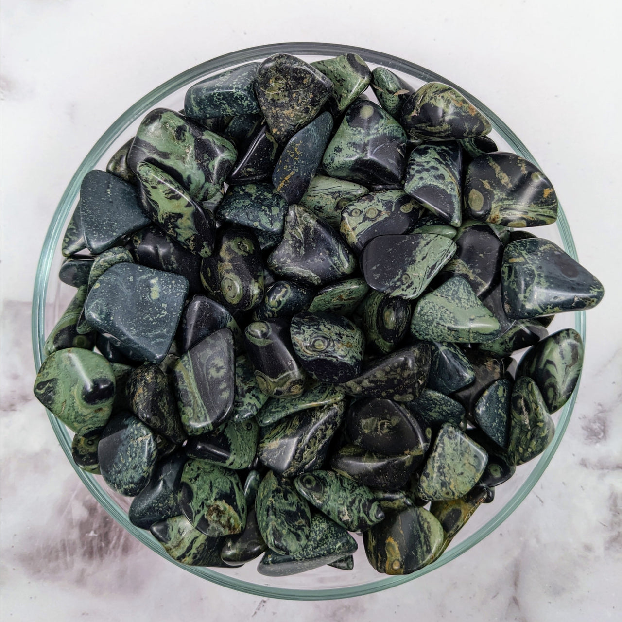 A bowl of Kambaba Jasper tumbled stones for sale in a 3-pack #LV3437