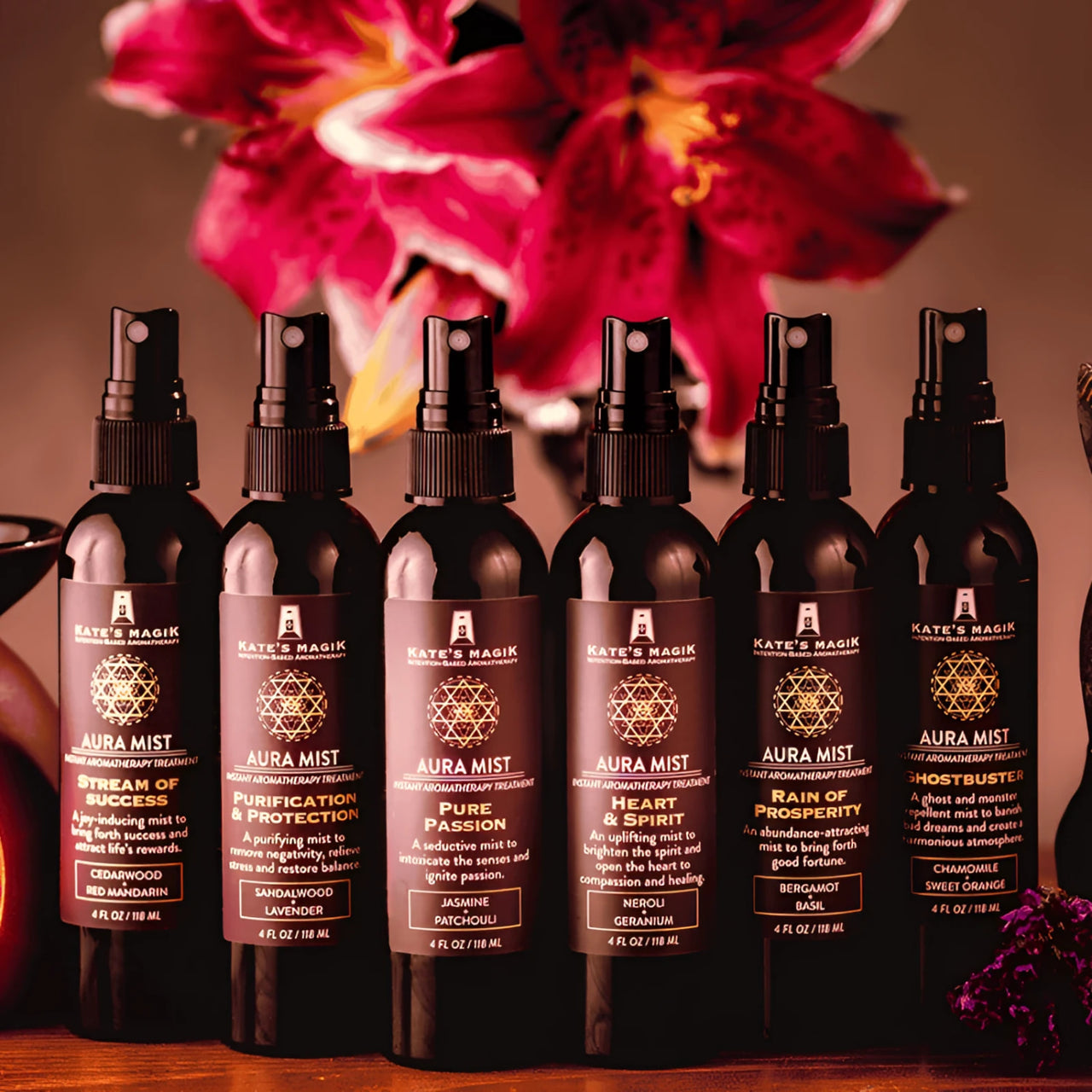 Six Kate’s Magik Aura Mist spray bottles in dark amber glass with scents