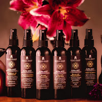 Six Kate’s Magik Aura Mist spray bottles in dark amber glass with scents