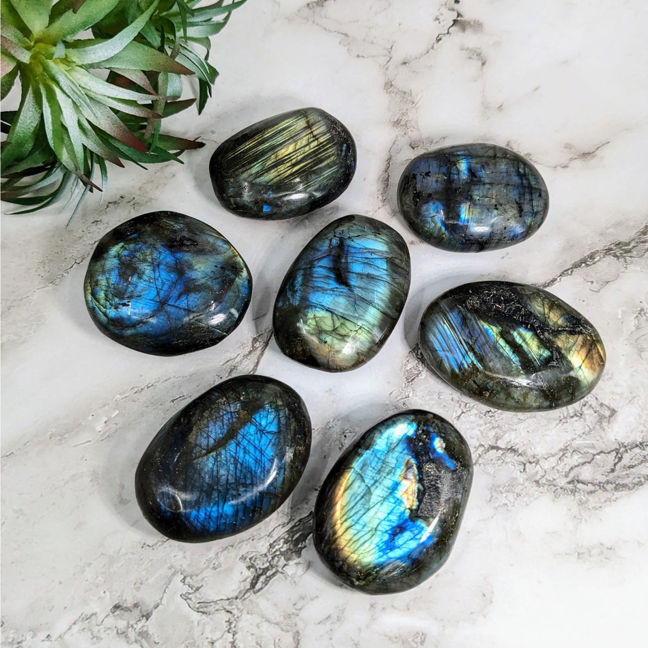 Close up of six medium labradorite palm stones on marble - Labradorite Palm Stone #LV4217