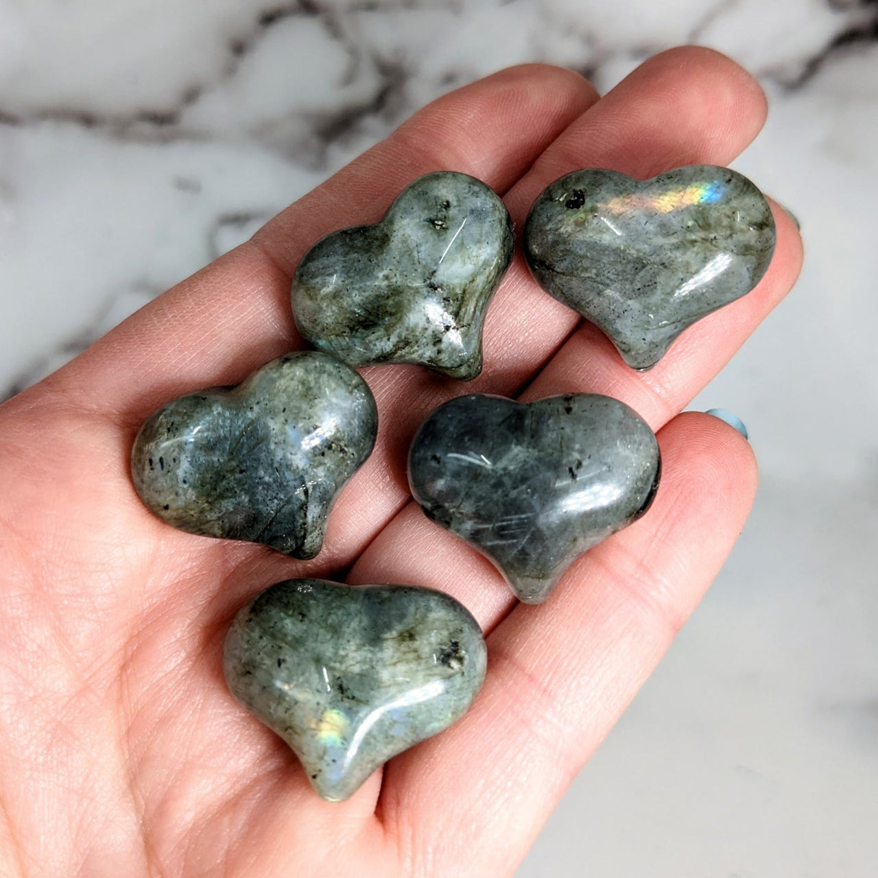 Person holding Labradorite mini puff hearts