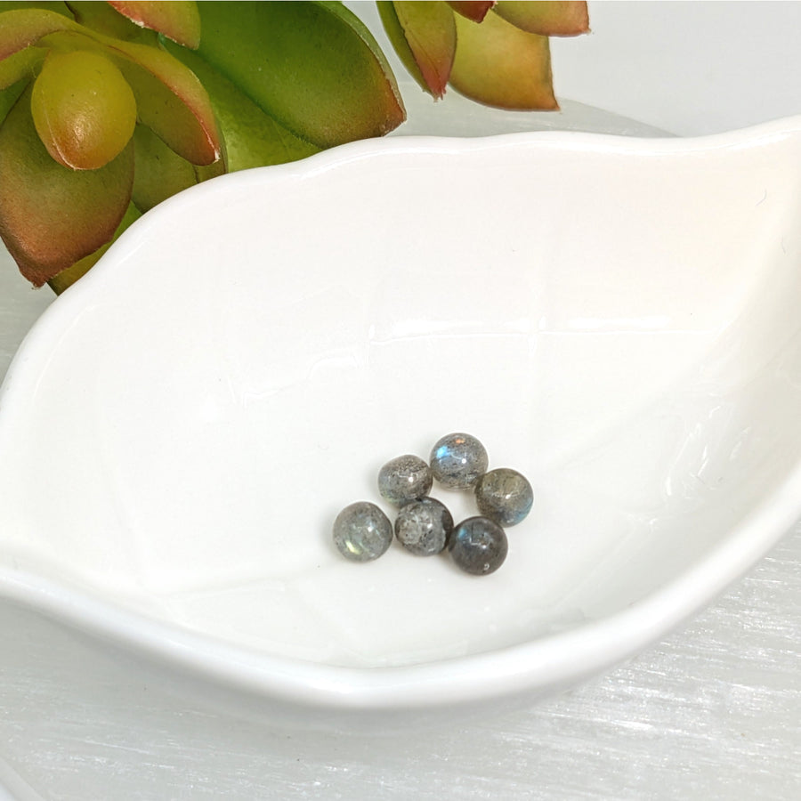 Seven gray round Labradorite beads from the Labradorite 4mm - 7mm Round Beads #LV7171 collection