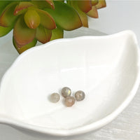 Thumbnail for White leaf-shaped ceramic dish with Labradorite 6mm faceted round beads displayed