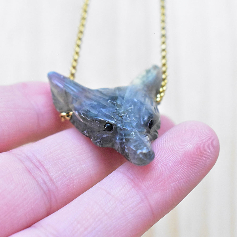 Translucent gray labradorite carved wolf pendant necklace on gold chain
