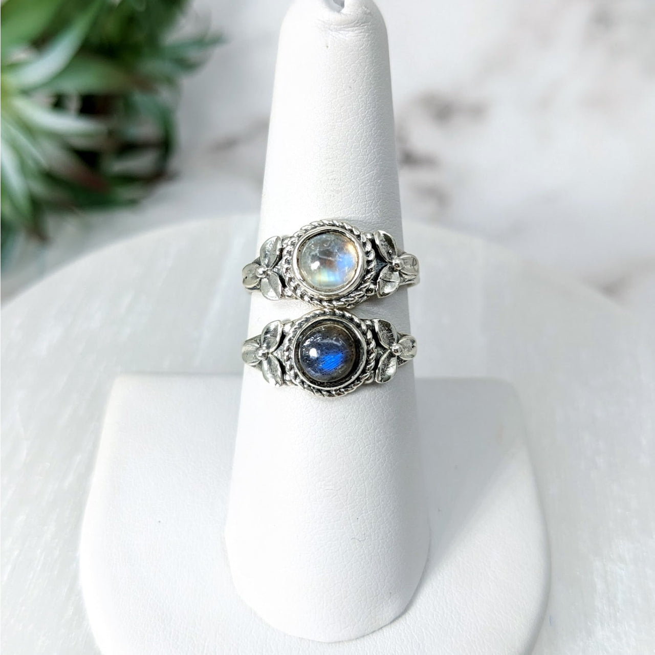 Labradorite or Moonstone Flower S.S. Ring #LV4614 on a white napkin with plant background