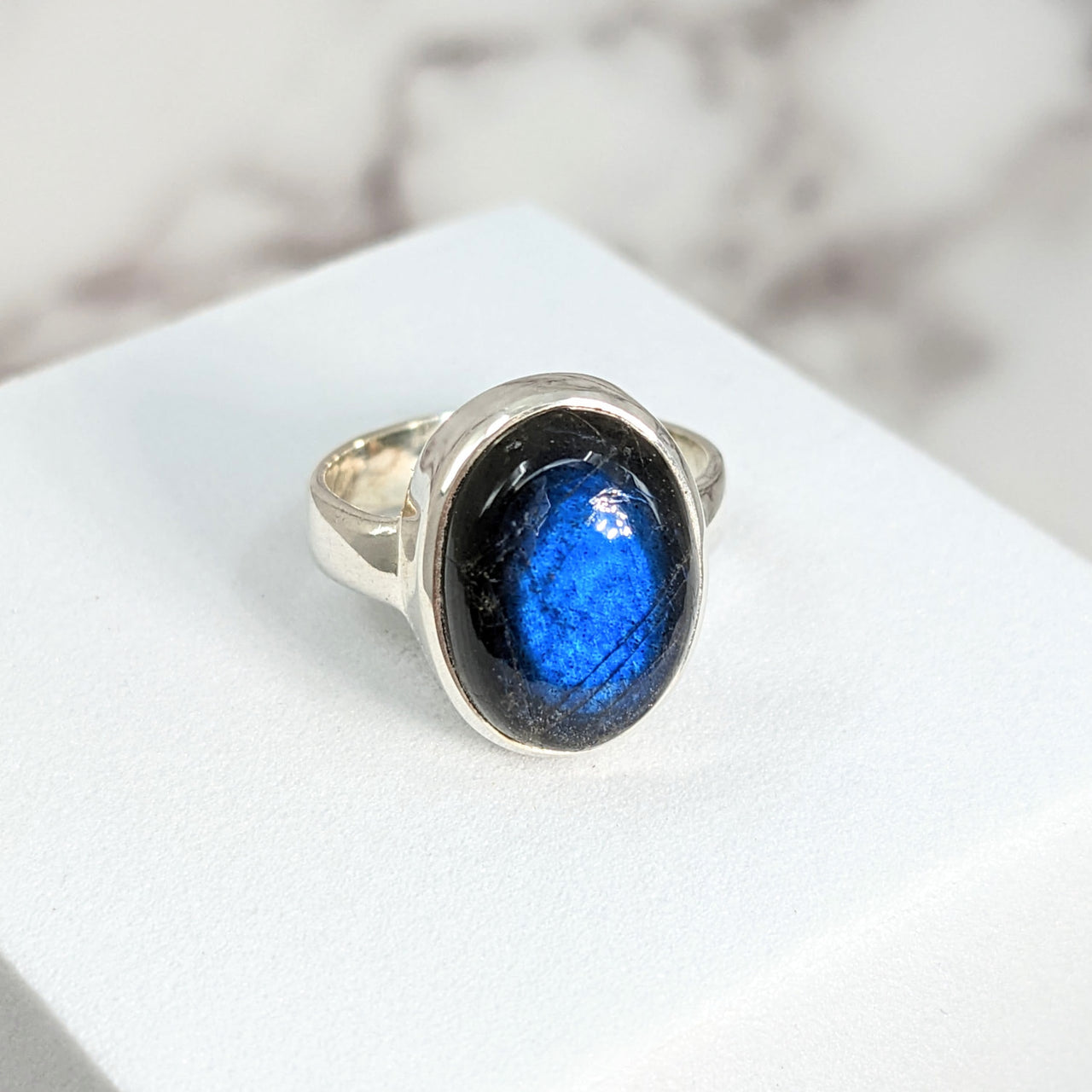 Labradorite Sz 5 Oval SS Ring #SK9513: Blue stone ring on a white surface